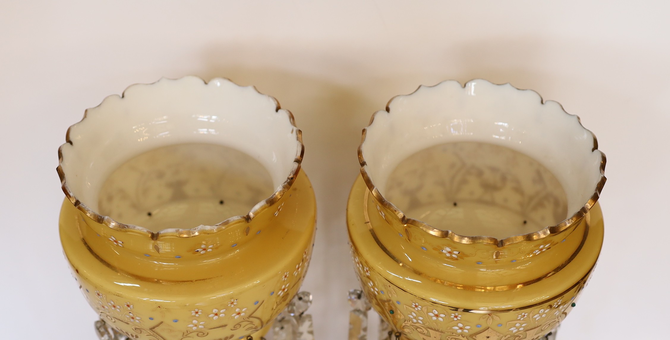 A pair of late 19th century Bohemian opaque glass lustres with enamelled and gilt floral decoration, height 37cm
